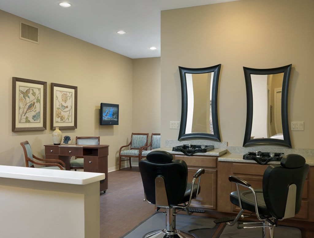 A modern salon interior with styling chairs and mirrors.