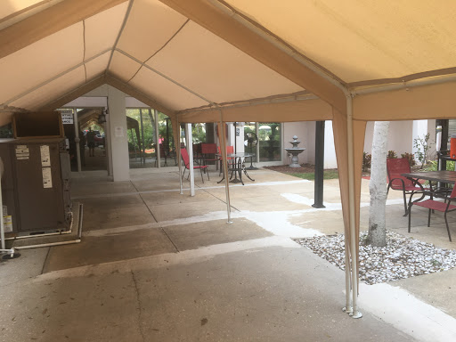A spacious covered outdoor area with a tent providing shade.
