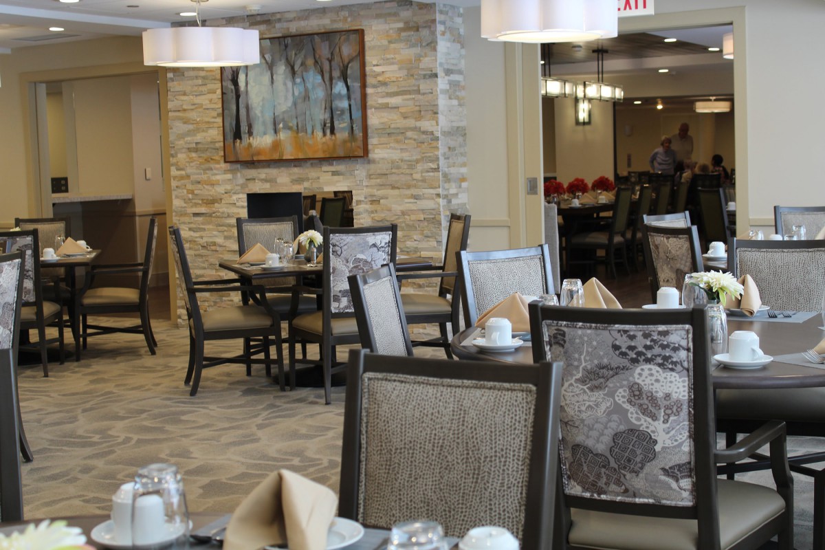 A modern dining room with neatly arranged tables and chairs, featuring stylish decor.