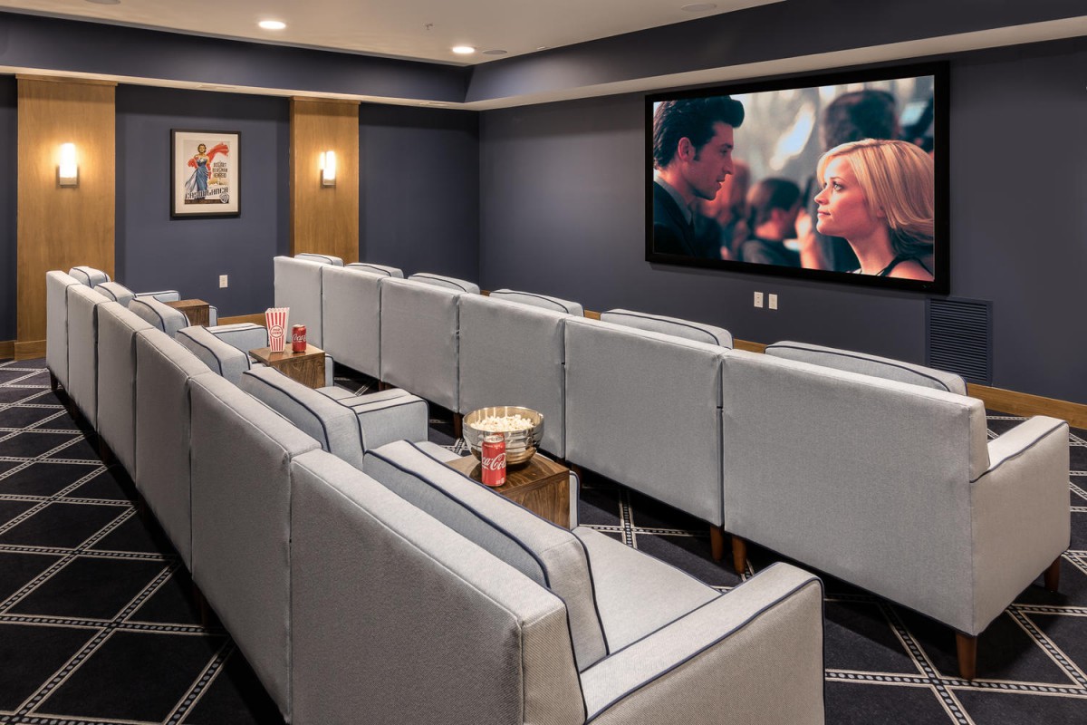 A luxurious home theater with comfortable seating and a large screen for viewing movies.