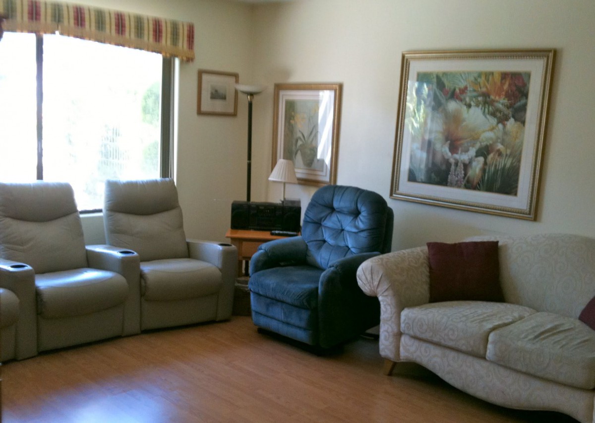 A cozy living room with comfortable seating and decorative artwork on the walls.