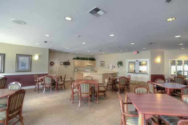 A well-lit dining area with tables and chairs arranged neatly.