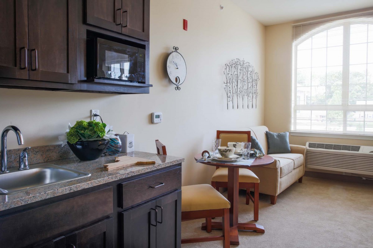 A cozy apartment interior with a kitchen and living area.