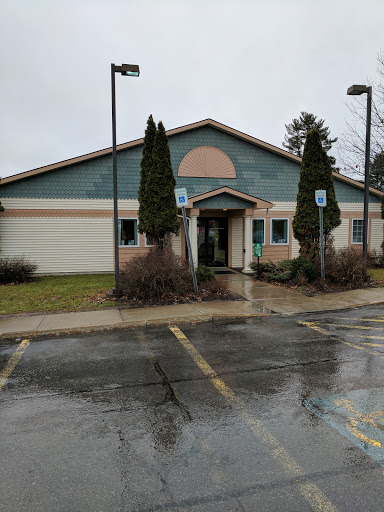 A modern building with a decorative facade on a rainy day.