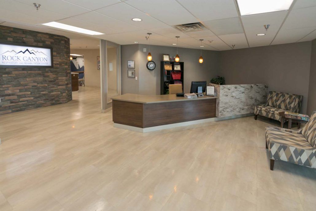 A modern office reception area with a front desk and stylish decor.