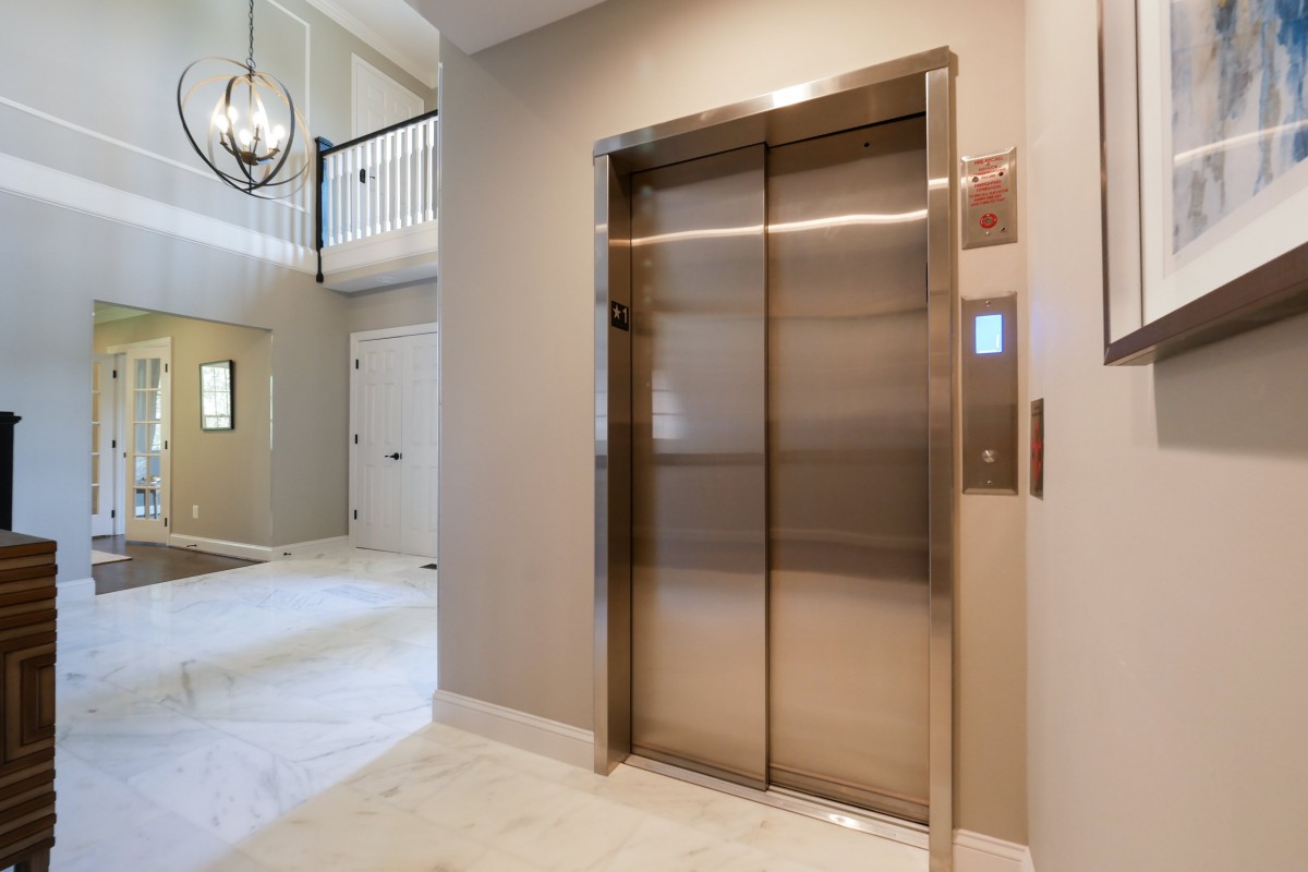 A modern elevator located in the hallway of a residential building.