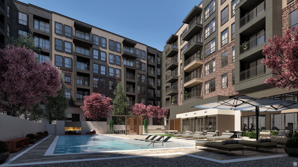 A modern apartment complex with a swimming pool and landscaped outdoor area.