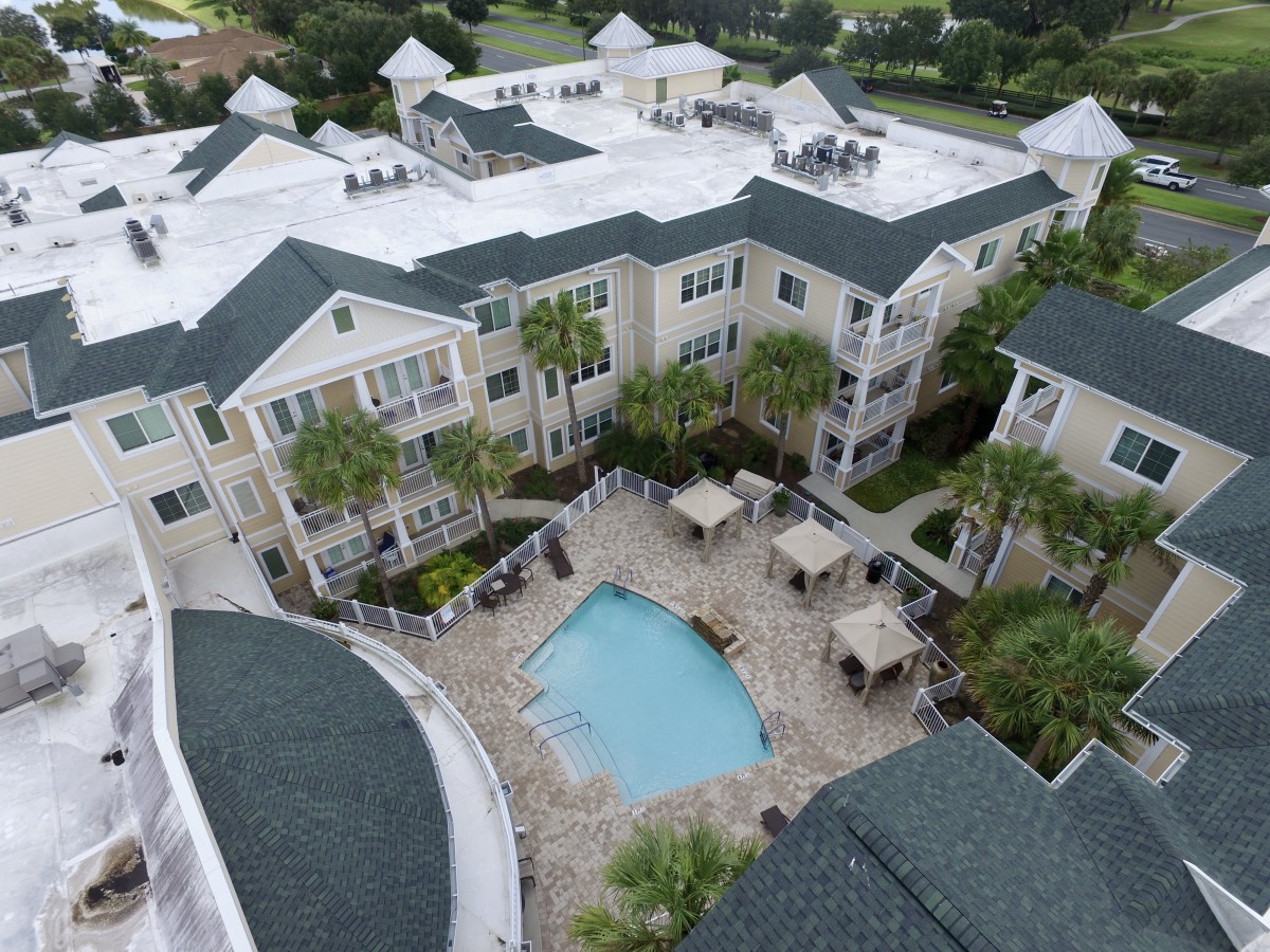 Aerial view of a residential apartment complex with a central pool.
