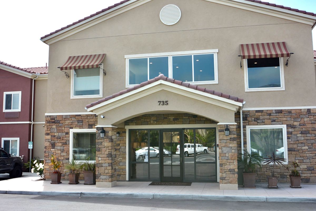 The front view of a commercial building with large windows and an inviting entrance.