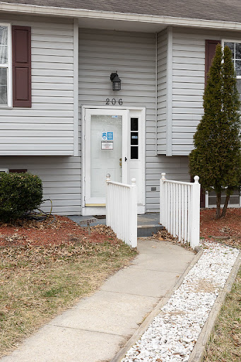 A welcoming entrance to a home with a clear pathway and simple landscaping.