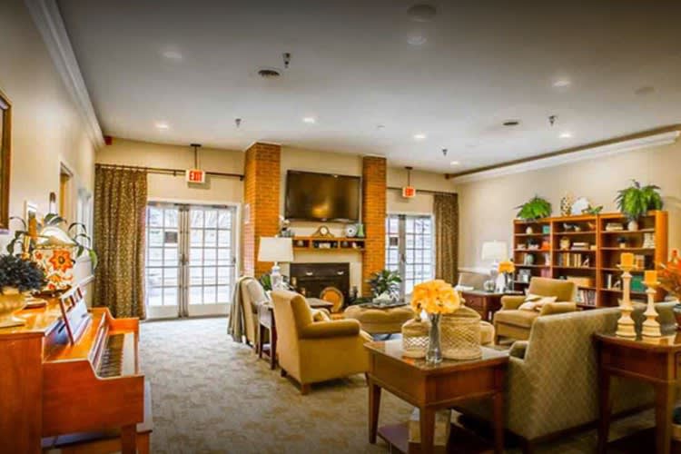 A cozy living room featuring comfortable seating, a fireplace, and a television.