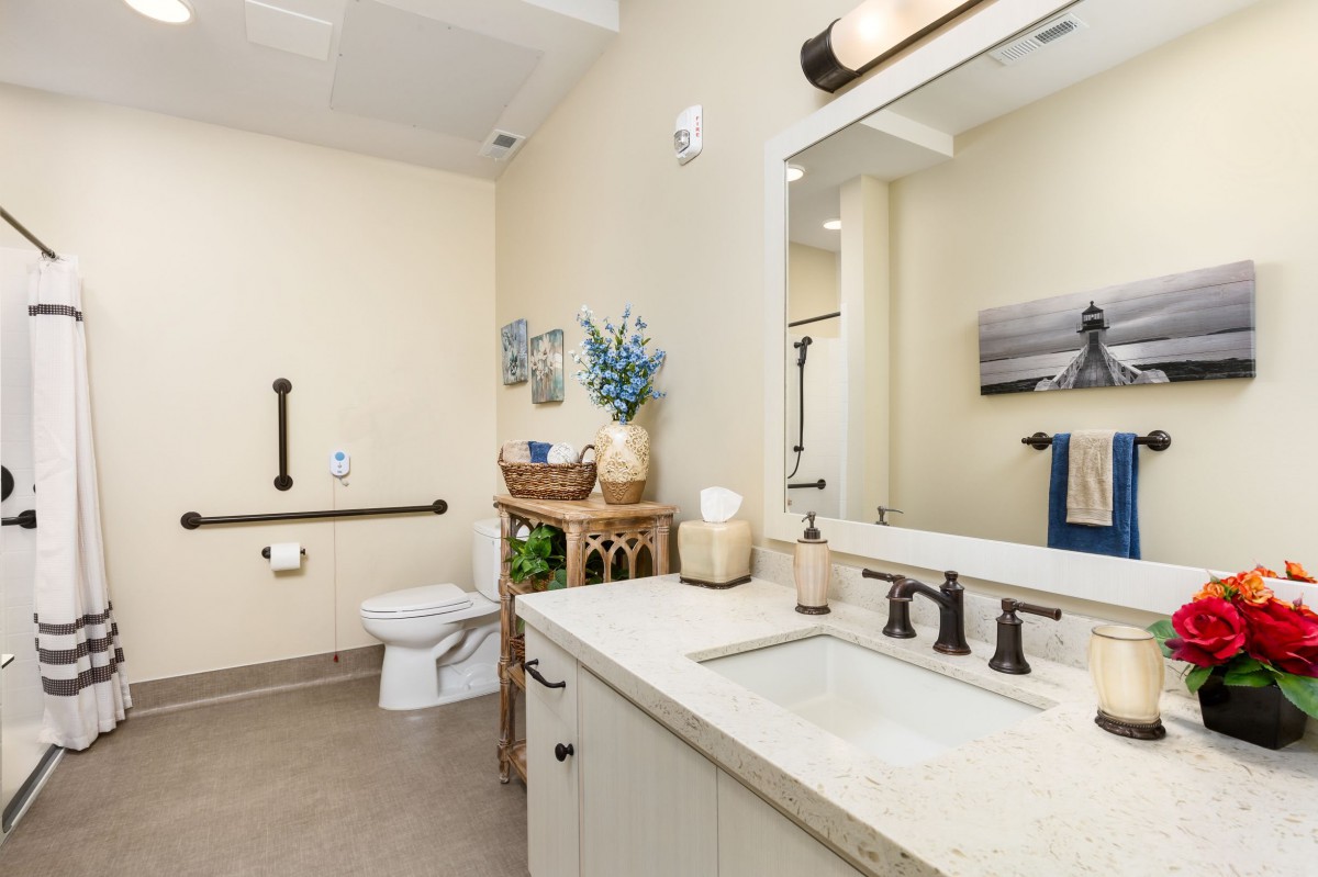 A modern bathroom with a well-organized sink area and stylish decor.