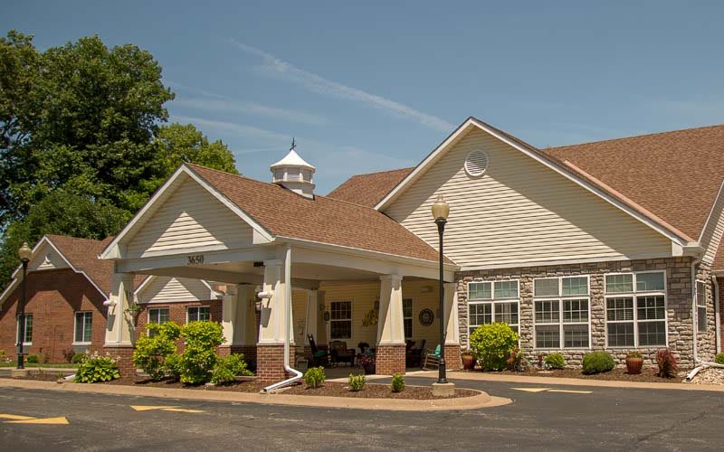 A view of a residential building with a landscaped entrance.