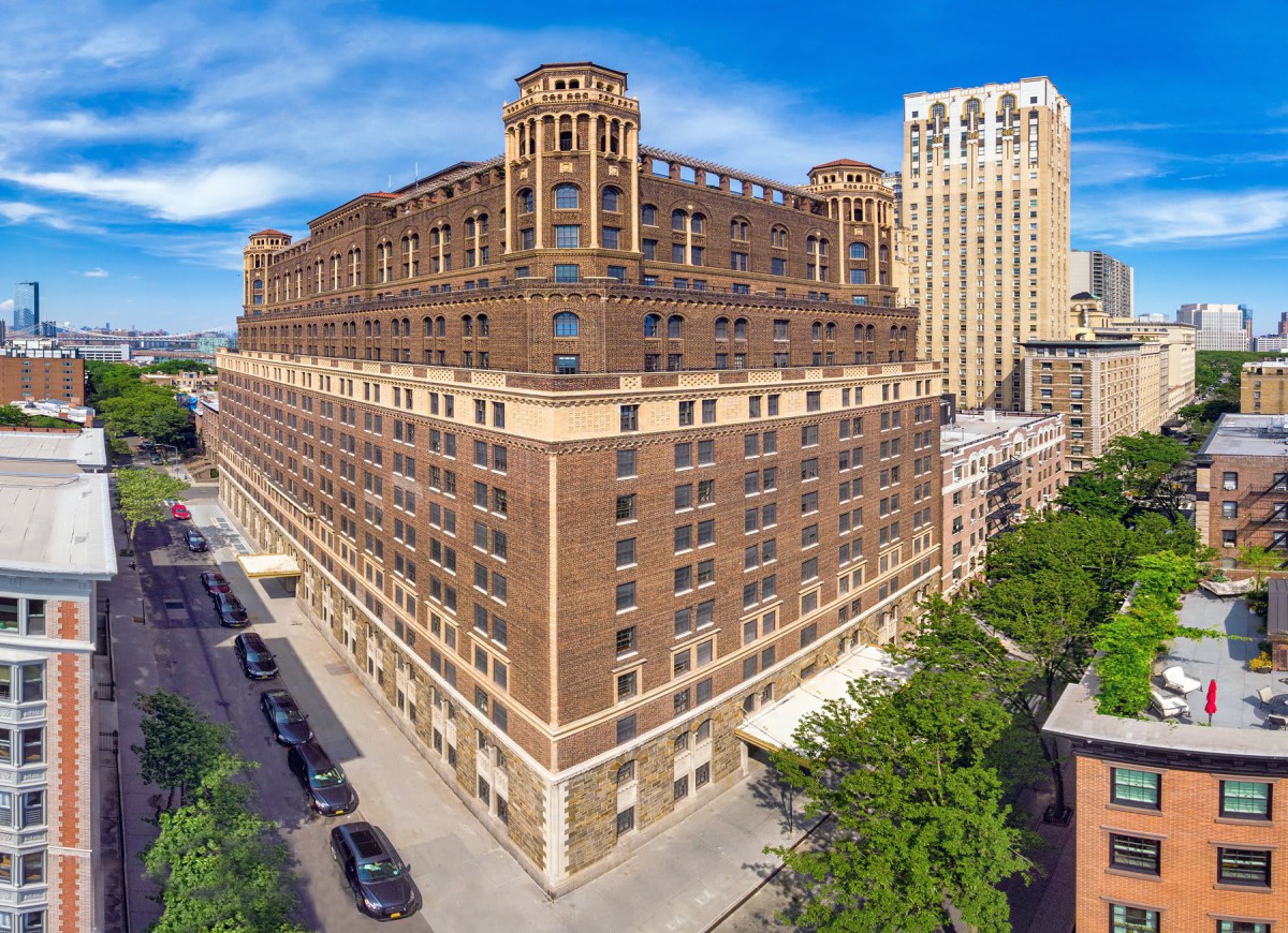 A historic urban building with intricate architecture dominates the city street.