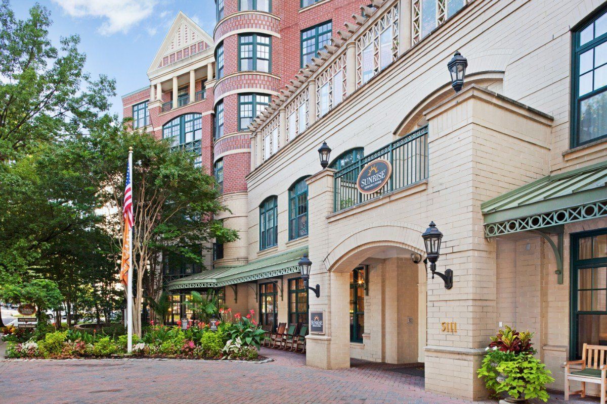 The exterior view of a hotel building with an elegant entrance and urban landscaping.