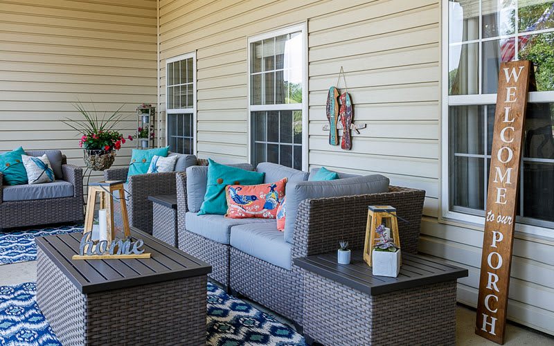 Cozy outdoor patio space with comfortable seating and colorful decor.