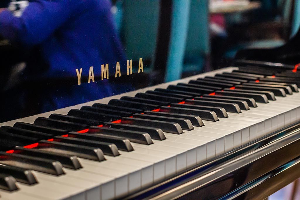 Close-up of a Yamaha piano keyboard.