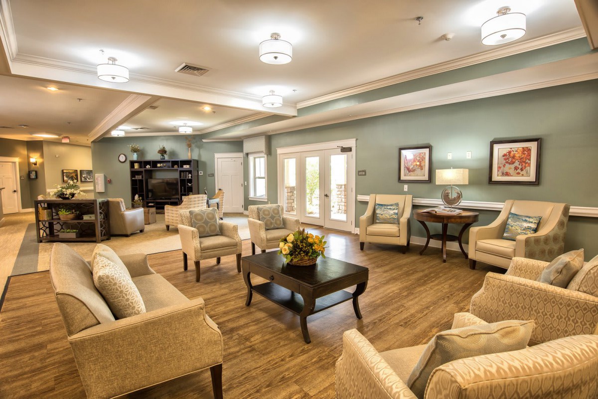 A cozy and modern lounge area with comfortable seating and warm lighting.