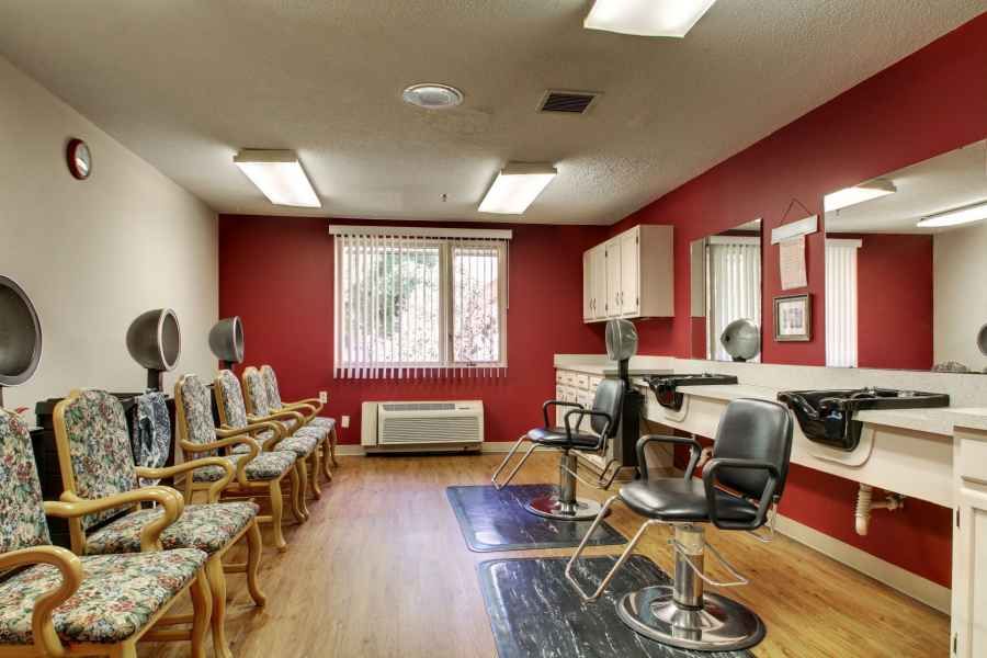 A salon interior with styling chairs, mirrors, and a waiting area.