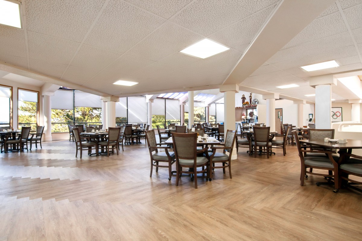 A spacious and modern dining area with neatly arranged tables and chairs.