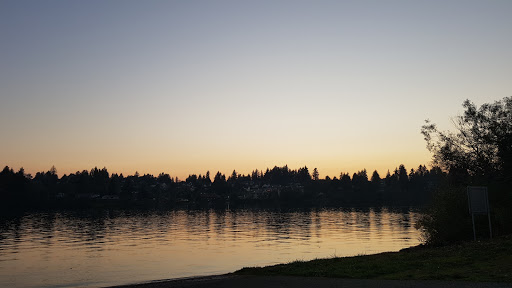 A tranquil sunset over the lake, casting reflections on the water.