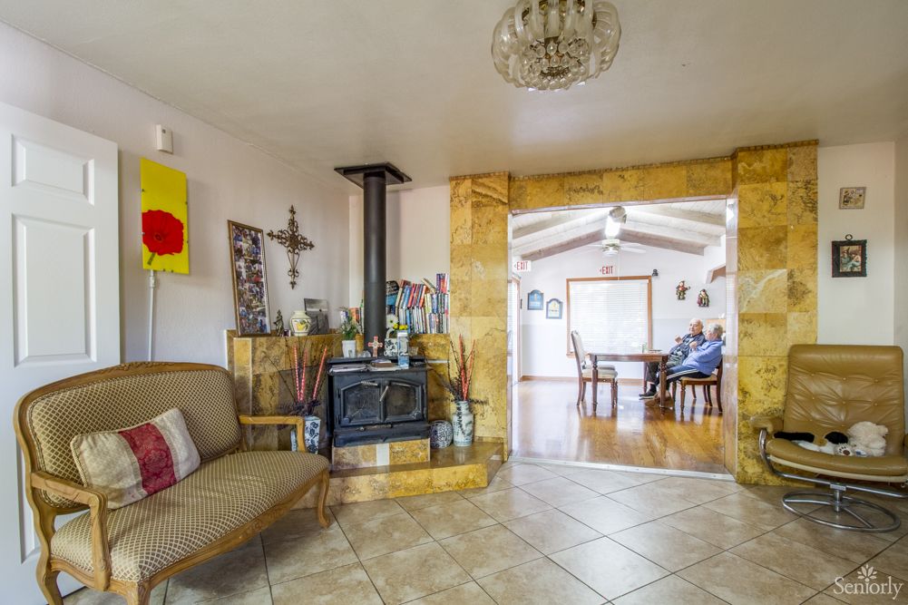 A cozy living room featuring a wood stove and comfortable seating in an open floor plan.