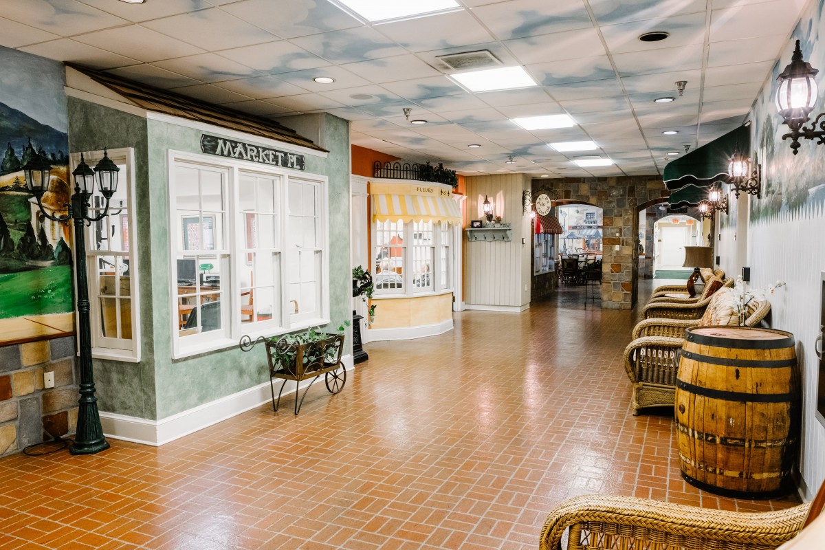 A vintage-themed hallway with shopfront displays and a brick floor.