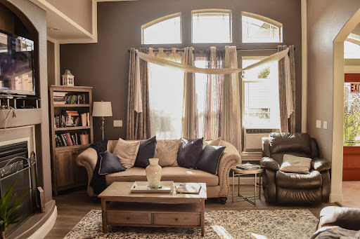 A warm and inviting living room filled with natural light, featuring a comfortable sofa and a wooden coffee table.