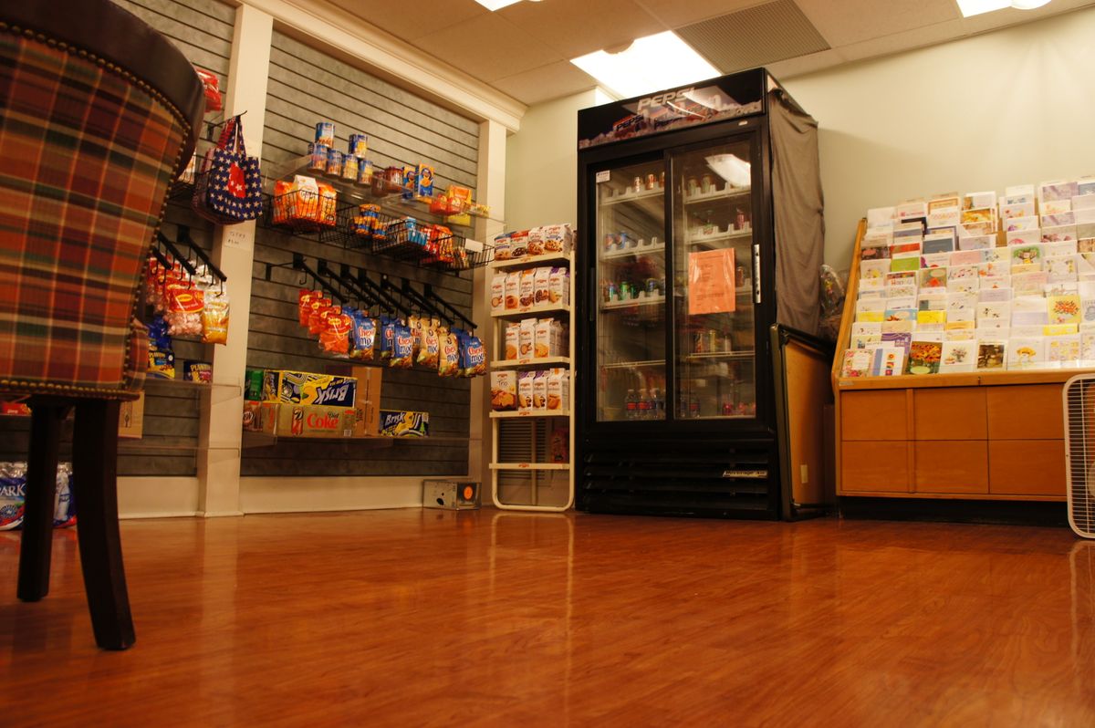 A small convenience store interior with snacks and drinks on display.