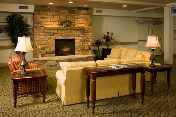 Cozy living room with a brick fireplace and comfortable seating.