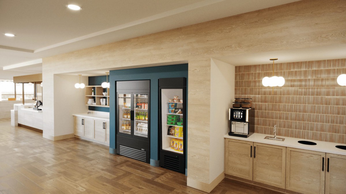 A modern snack and beverage area featuring vending machines, beverage refrigerators, and a coffee station.