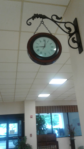 A classic wall clock displaying the time in a well-lit interior space.