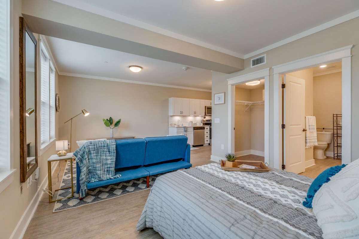 Modern studio apartment with open-plan living and bedroom area.