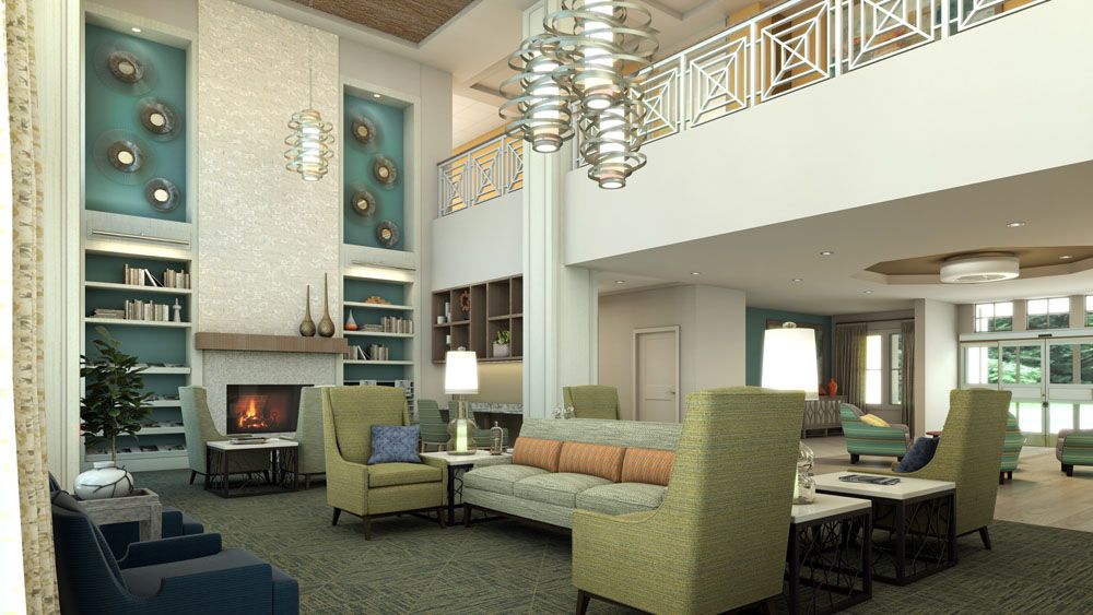 A modern living room with elegant furniture, featuring a chandelier and a cozy fireplace.