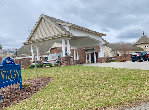 A residential building with a welcoming entrance on a cloudy day.