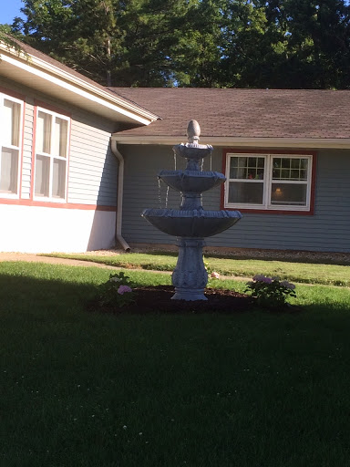 A beautiful fountain situated in a well-maintained yard.
