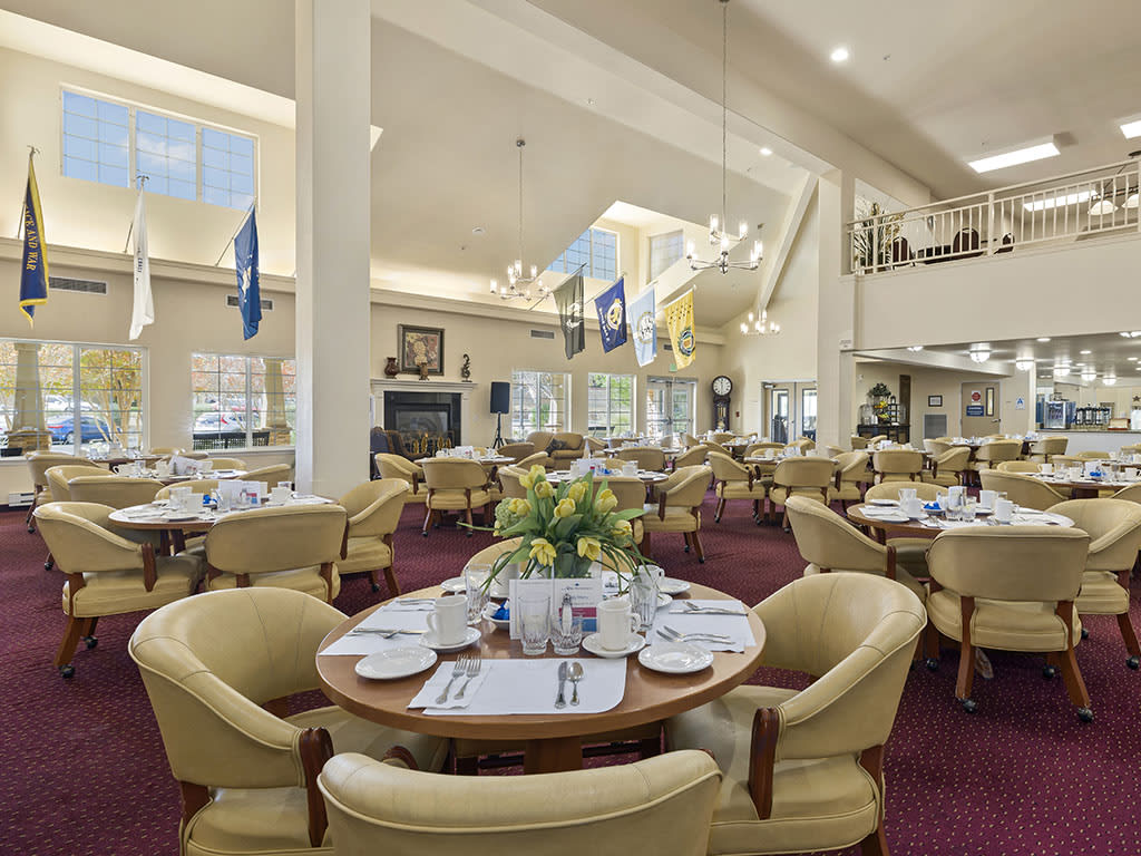 An elegant dining room with neatly arranged tables and chairs, ready for guests.
