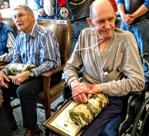 A gathering of veterans honored at a ceremony, showcasing the camaraderie and respect for their service.