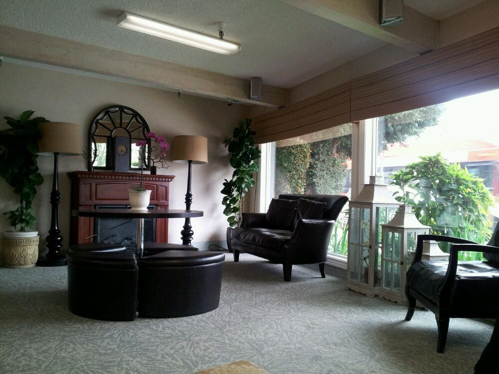 A cozy living room with elegant furniture and a large window, creating a welcoming ambiance.