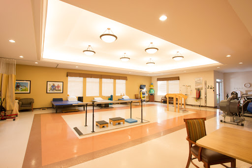 A spacious and well-lit rehabilitation room designed for physical therapy.