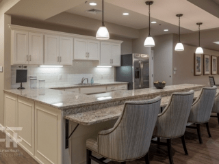 A modern kitchen with pendant lighting and a spacious countertop featuring elegant bar stools.
