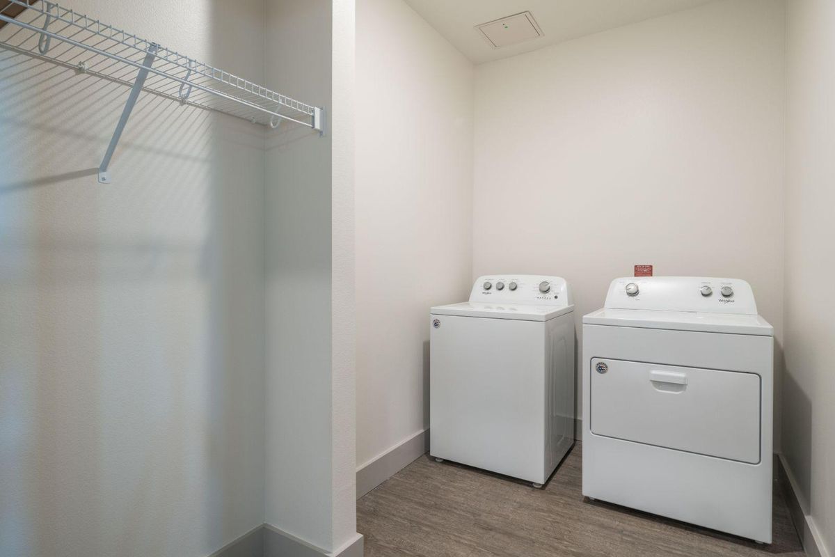 A minimalist laundry room with a washer and dryer set.