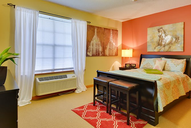 A cozy bedroom with warm colors and modern decor.