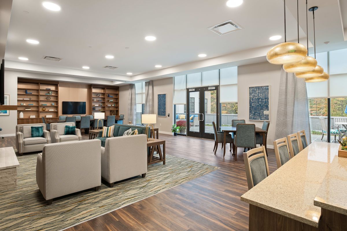 A modern and spacious lounge area with comfortable seating and natural lighting.