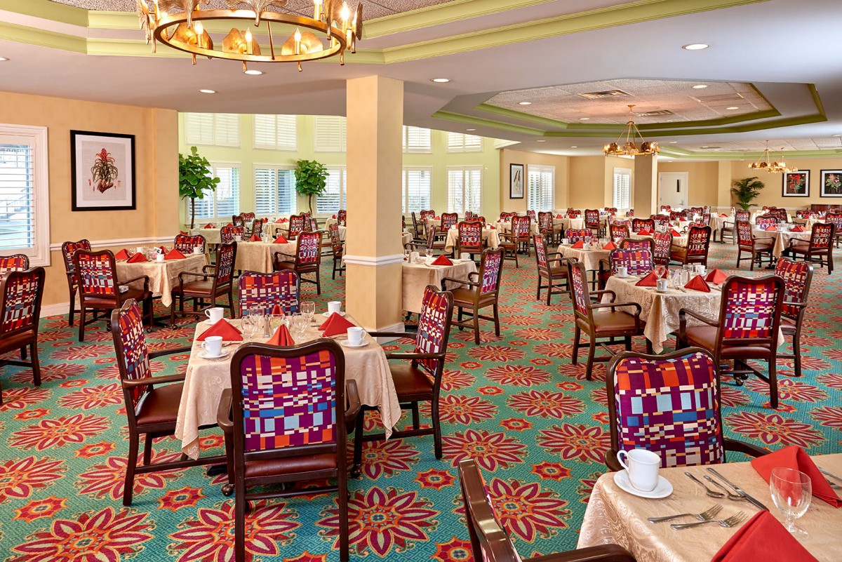 An elegantly decorated dining room with neatly arranged tables and chairs.
