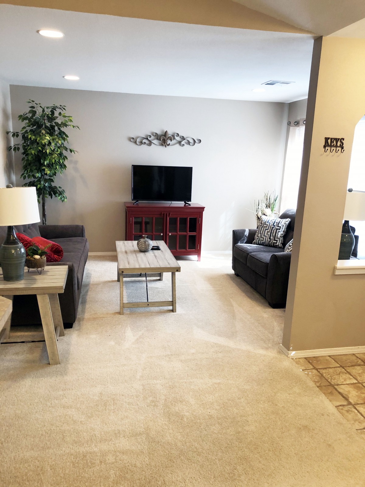 A modern living room featuring a cozy seating area, television, and elegant decor.