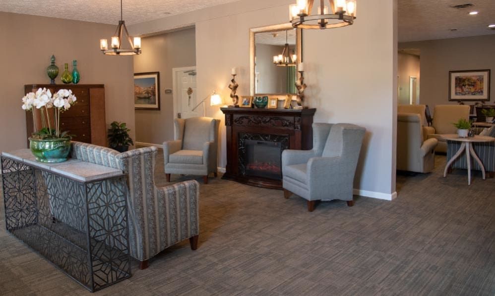 A cozy living room with armchairs, a fireplace, and elegant decor.