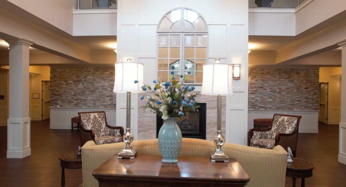 A cozy living room with a decorative vase of flowers and elegant lamps.
