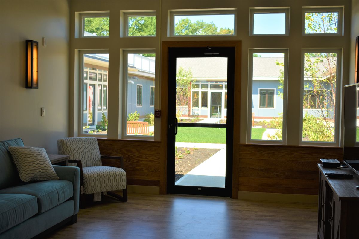 A cozy lobby area with large windows and a view of the outdoors.