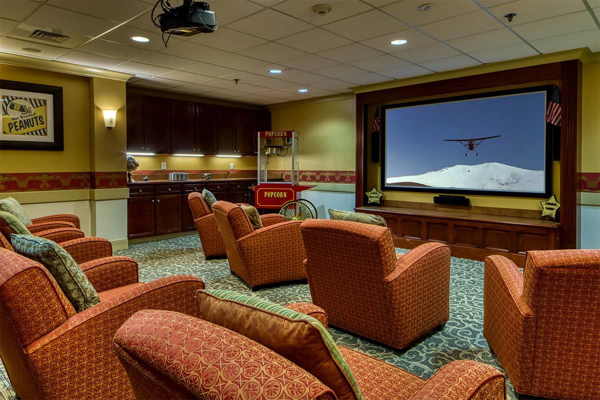 A cozy home theater setup with comfortable seating and a large screen for movie watching.